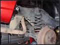RE8003 Showing track bar loose on right side and shock removed.