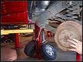 RE8003 Removing left rear lower control arm from unibody.
