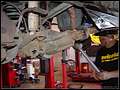 RE8003 Showing installing right side new lower control arm.